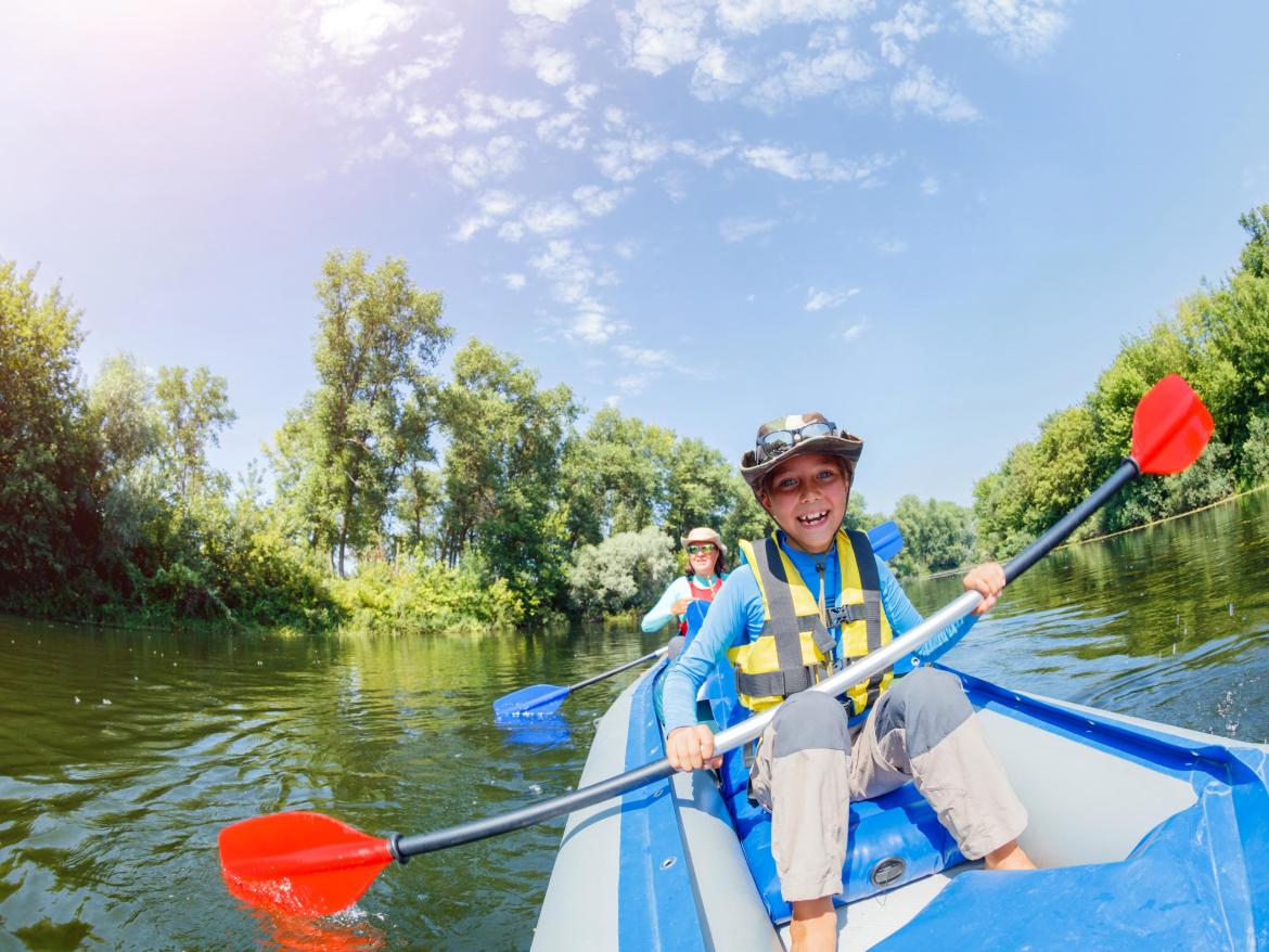 enfants faisant du canoe sur une riviere